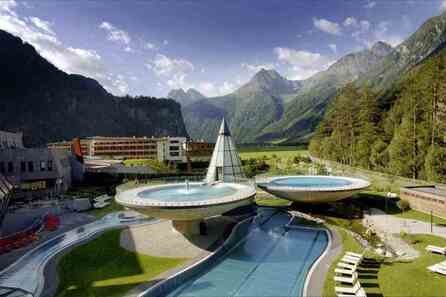 The view of Aqua Dome spa hotel surrounded by stunning mountain ranges