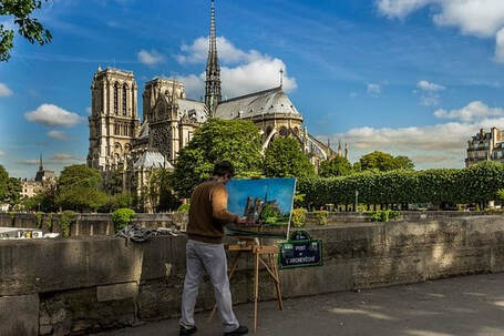A man painting the Notre Dame Cathedral in Paris, France