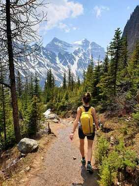 An adventurous woman hikes through the mountains