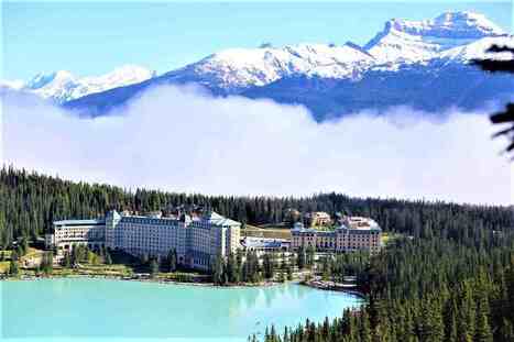 Image of Fairmont Château Lake Louise surrounded by majestic Rocky Mountains